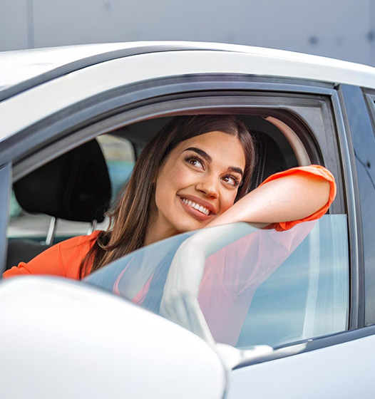 A right close up of a yellow Mercedes AMG sports car headlight on a city street