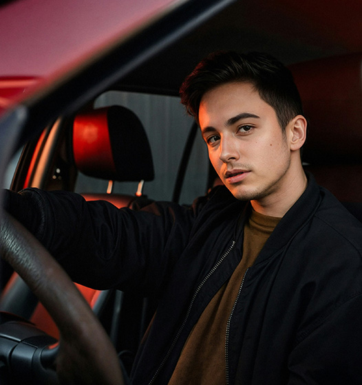 A right close up of a yellow Mercedes AMG sports car headlight on a city street