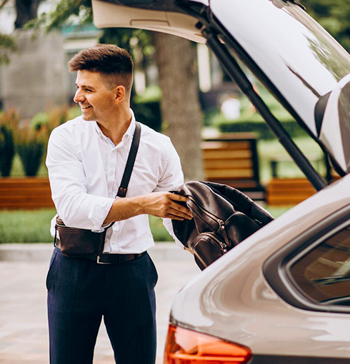 A right close up of a yellow Mercedes AMG sports car headlight on a city street