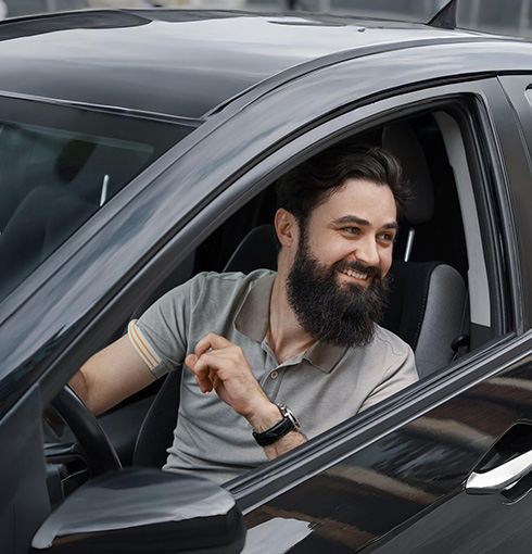 A right close up of a yellow Mercedes AMG sports car headlight on a city street