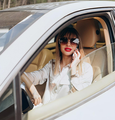 A right close up of a yellow Mercedes AMG sports car headlight on a city street