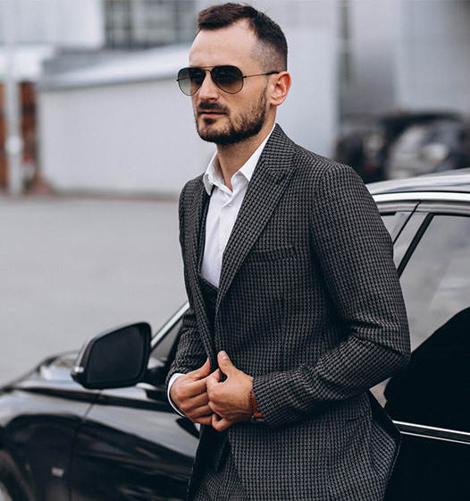 A right close up of a yellow Mercedes AMG sports car headlight on a city street